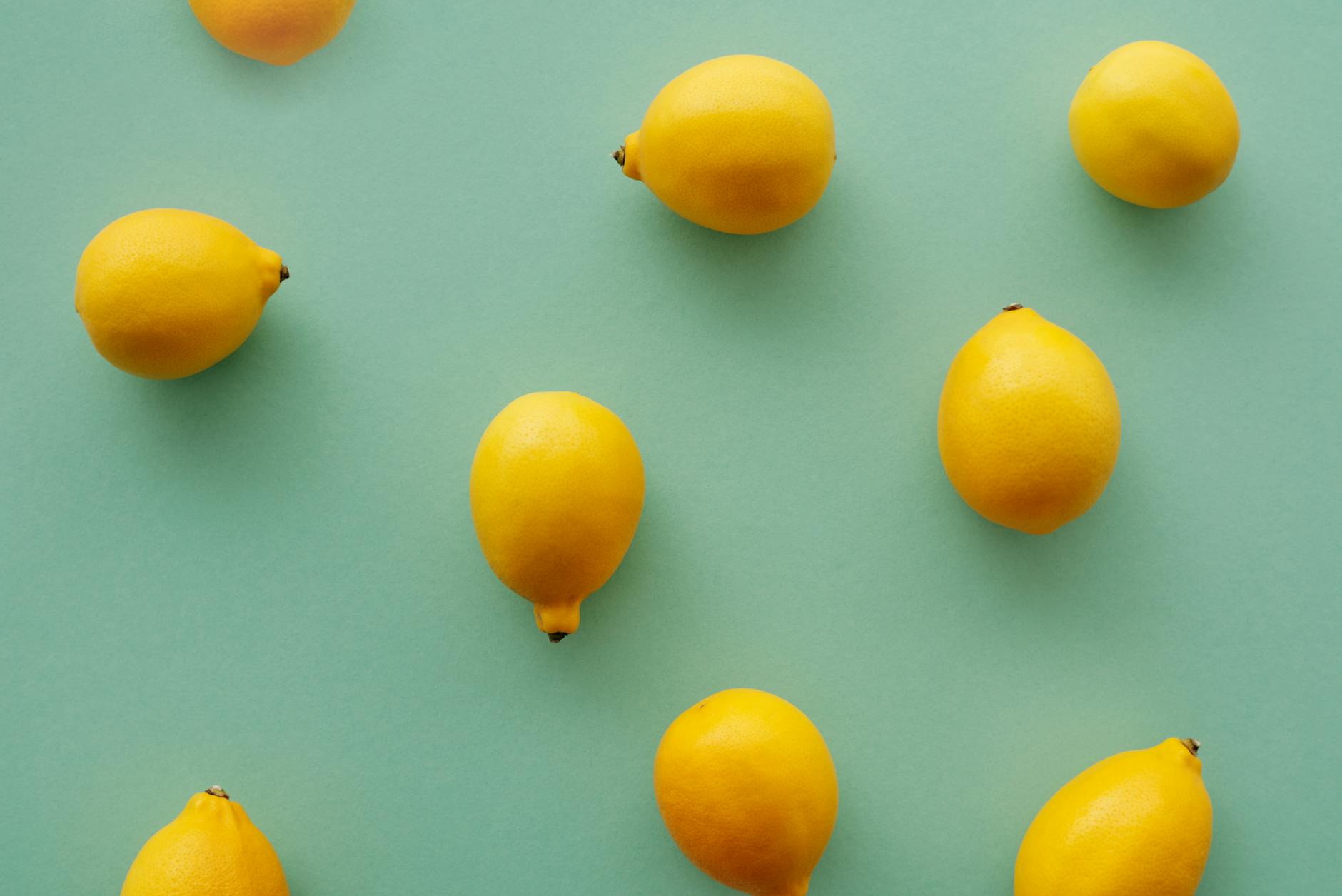 Fresh yellow lemons on a soft green background symbolizing the natural advantage of lemon vibrators for mature bodies